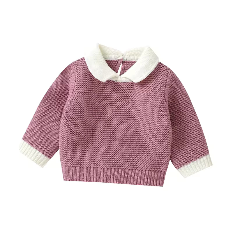 Pink knitted sweater with white collar on a white background