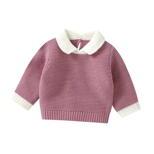Pink knitted sweater with white collar on a white background